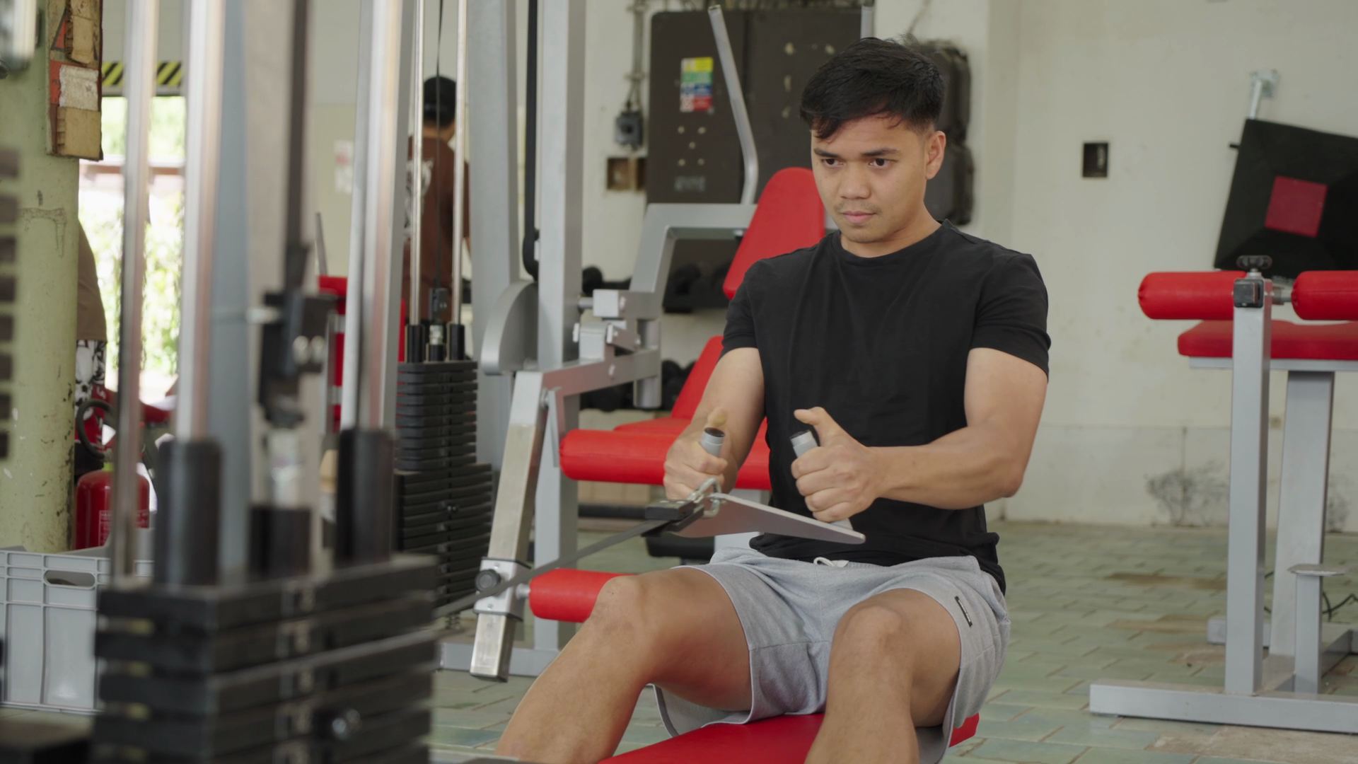 A colleague training on the cable machine in the gym