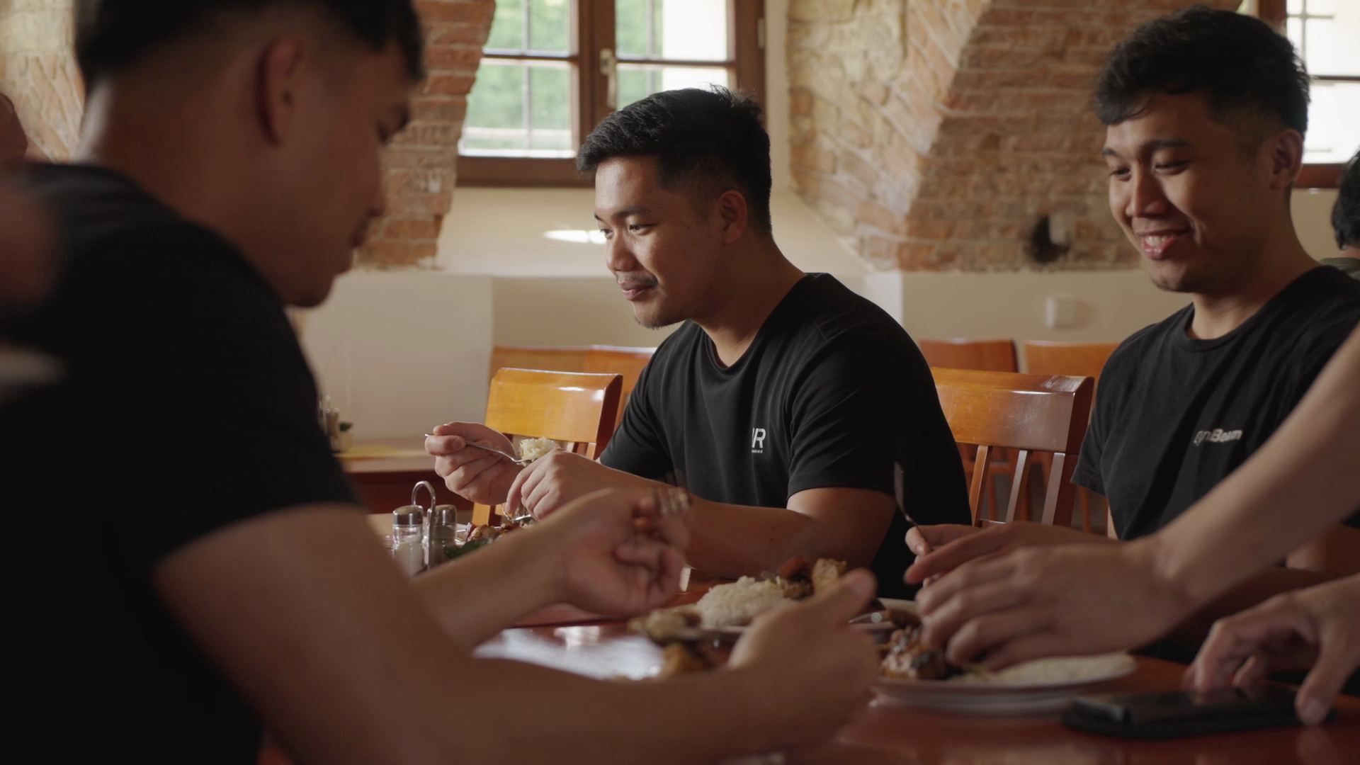 Four colleagues eating together at a long table
