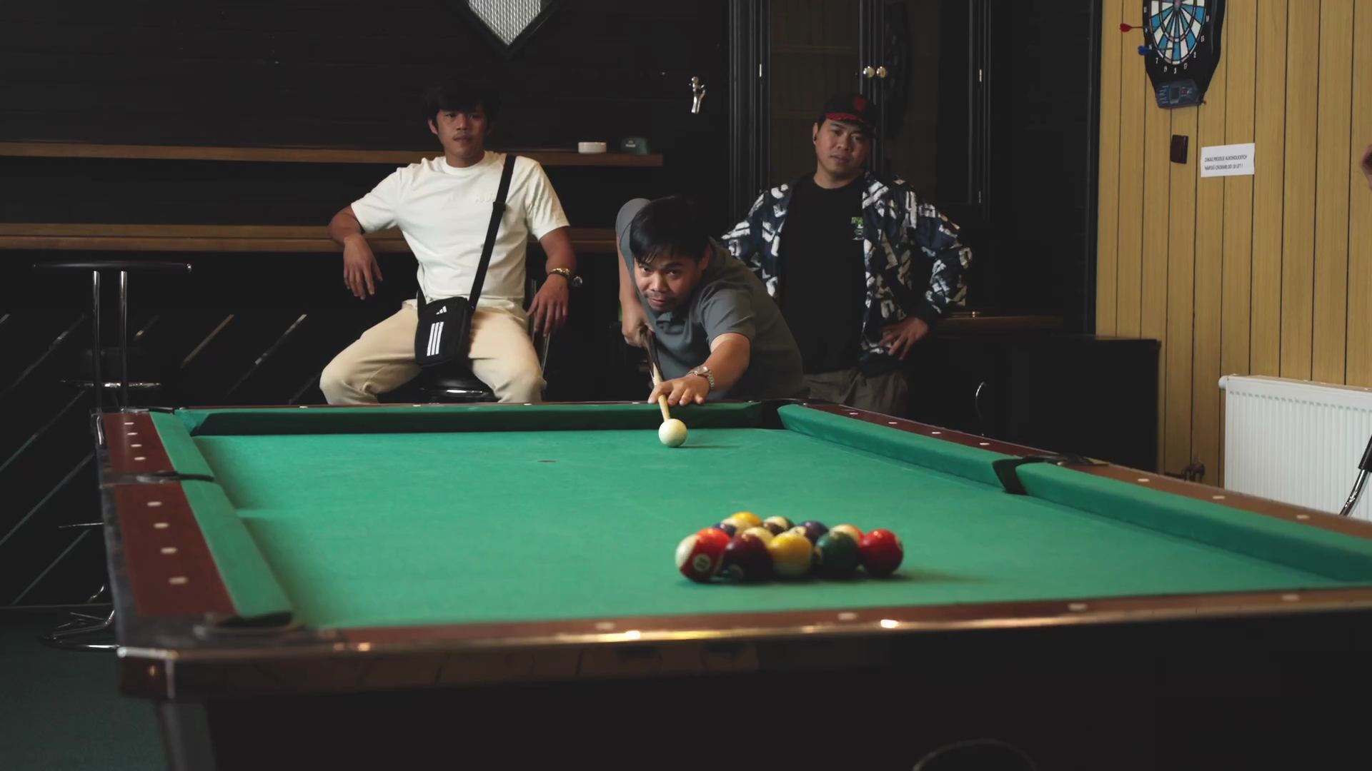 Colleagues playing billiards in the games room